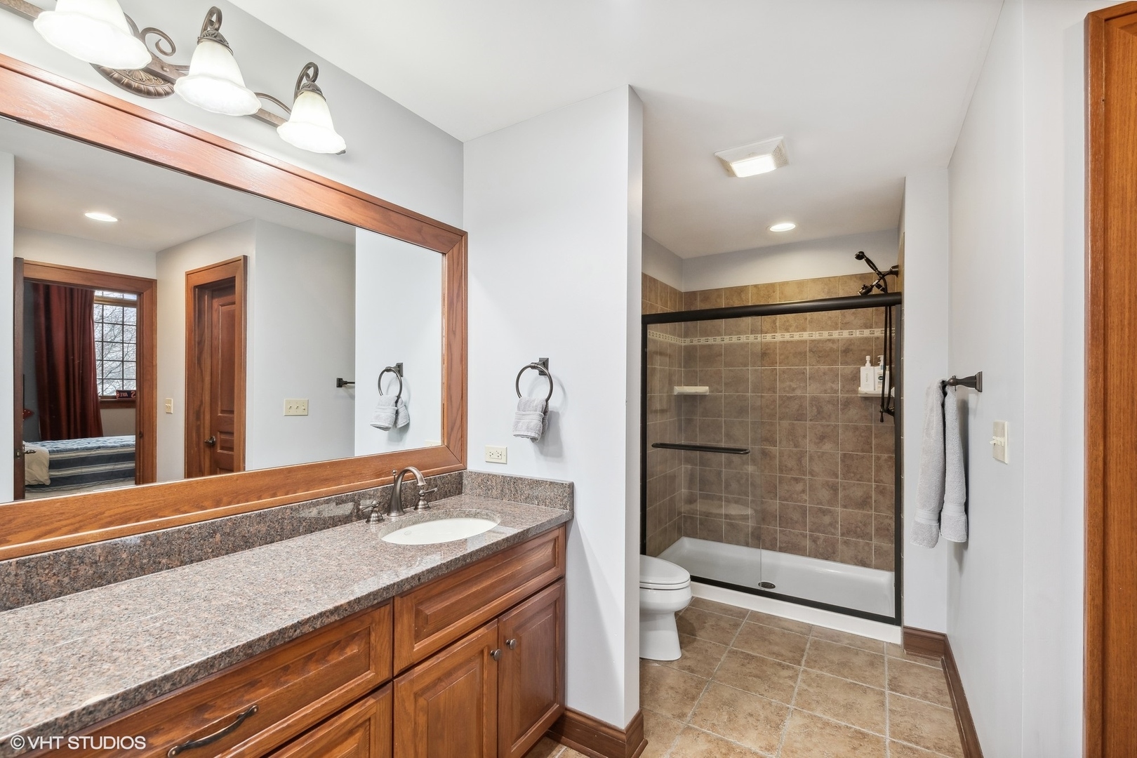 381 Argyle Avenue Elmhurst, IL 60126 - Photo 35 of 63 a bathroom with a granite countertop sink a toilet a mirror and shower