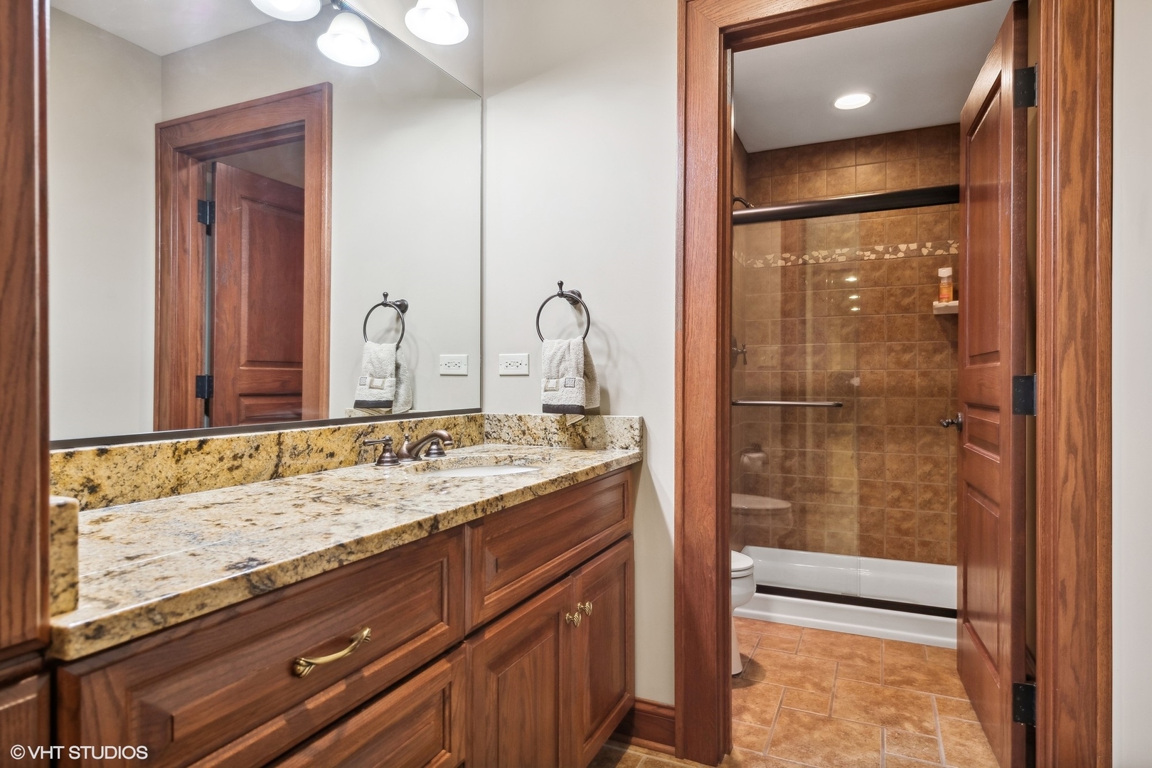 381 Argyle Avenue Elmhurst, IL 60126 - Photo 48 of 63 a bathroom with a granite countertop sink a mirror and a shower