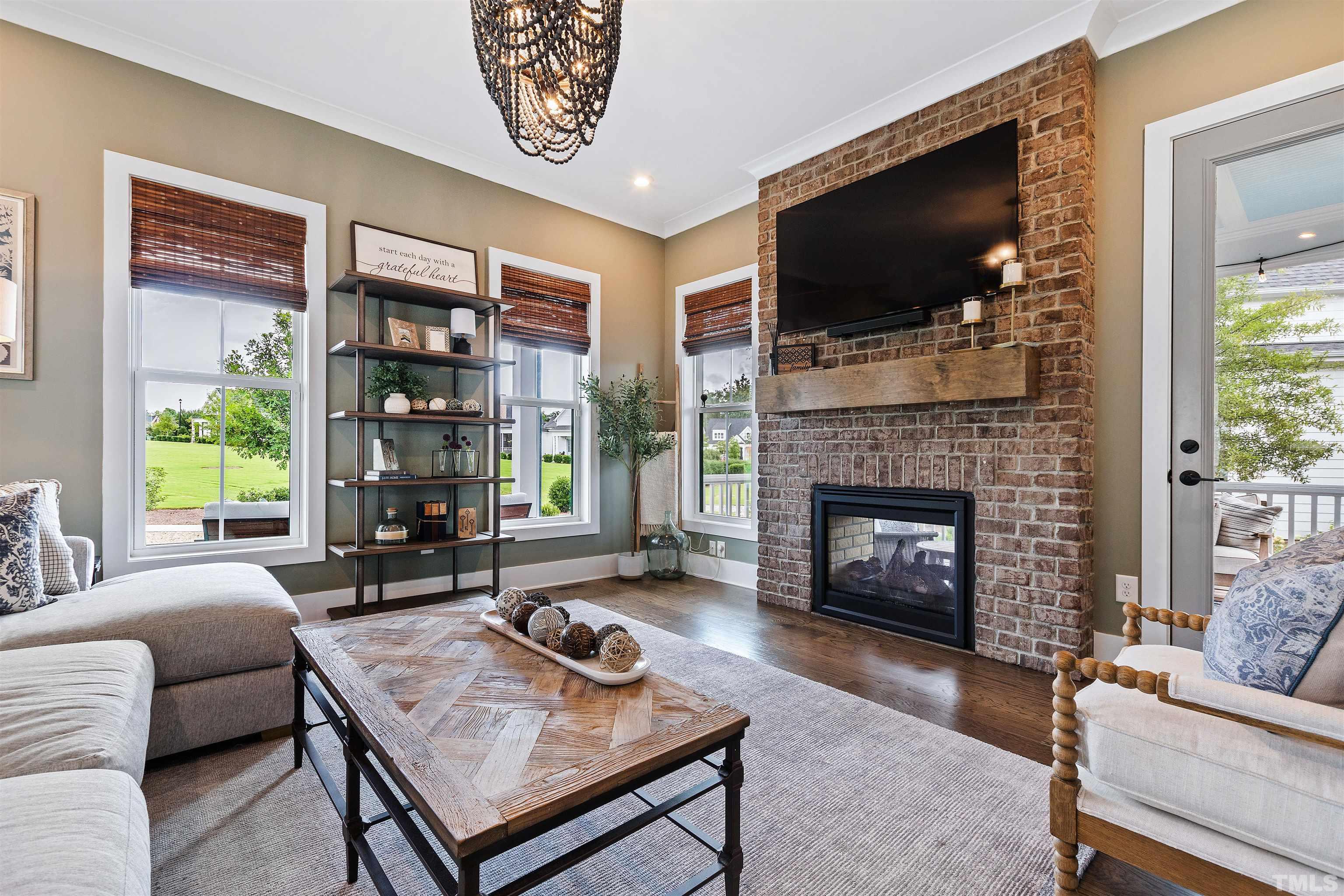 700 Daniel Ridge Rd. Wendell, NC 27591 - Photo 11 of 62 a living room with furniture a flat screen tv and a fireplace