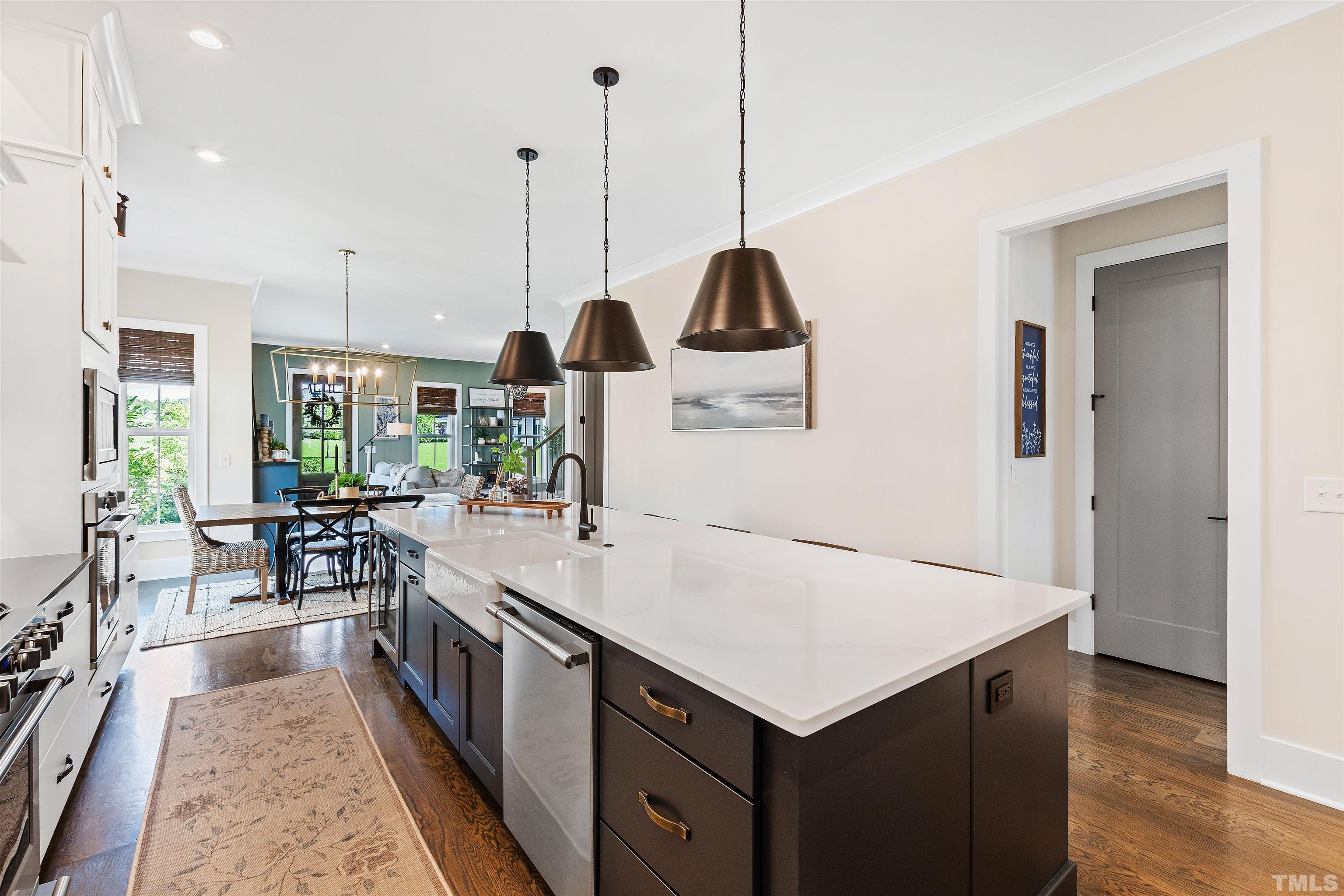 700 Daniel Ridge Rd. Wendell, NC 27591 - Photo 18 of 62 a kitchen with a stove a sink a center island and living room view