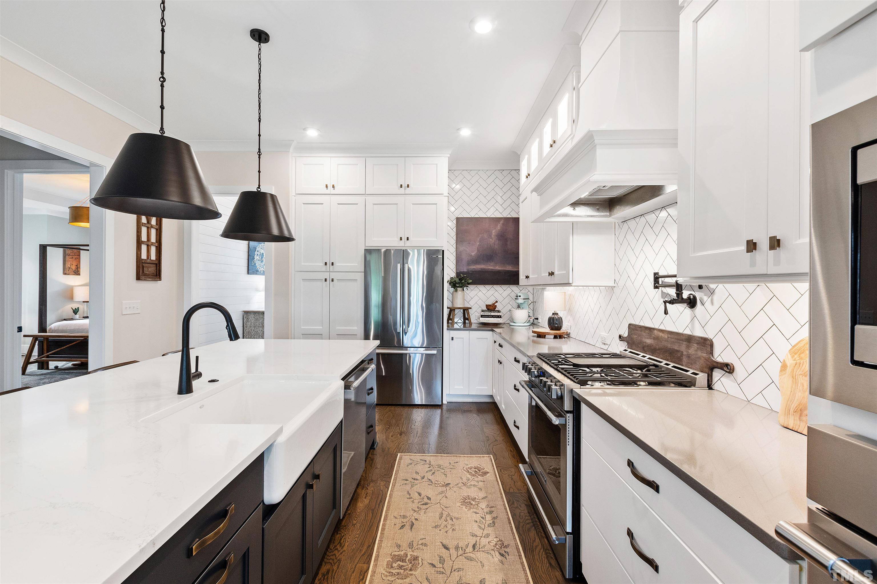 700 Daniel Ridge Rd. Wendell, NC 27591 - Photo 22 of 62 a kitchen with kitchen island a counter space a sink a stove and refrigerator