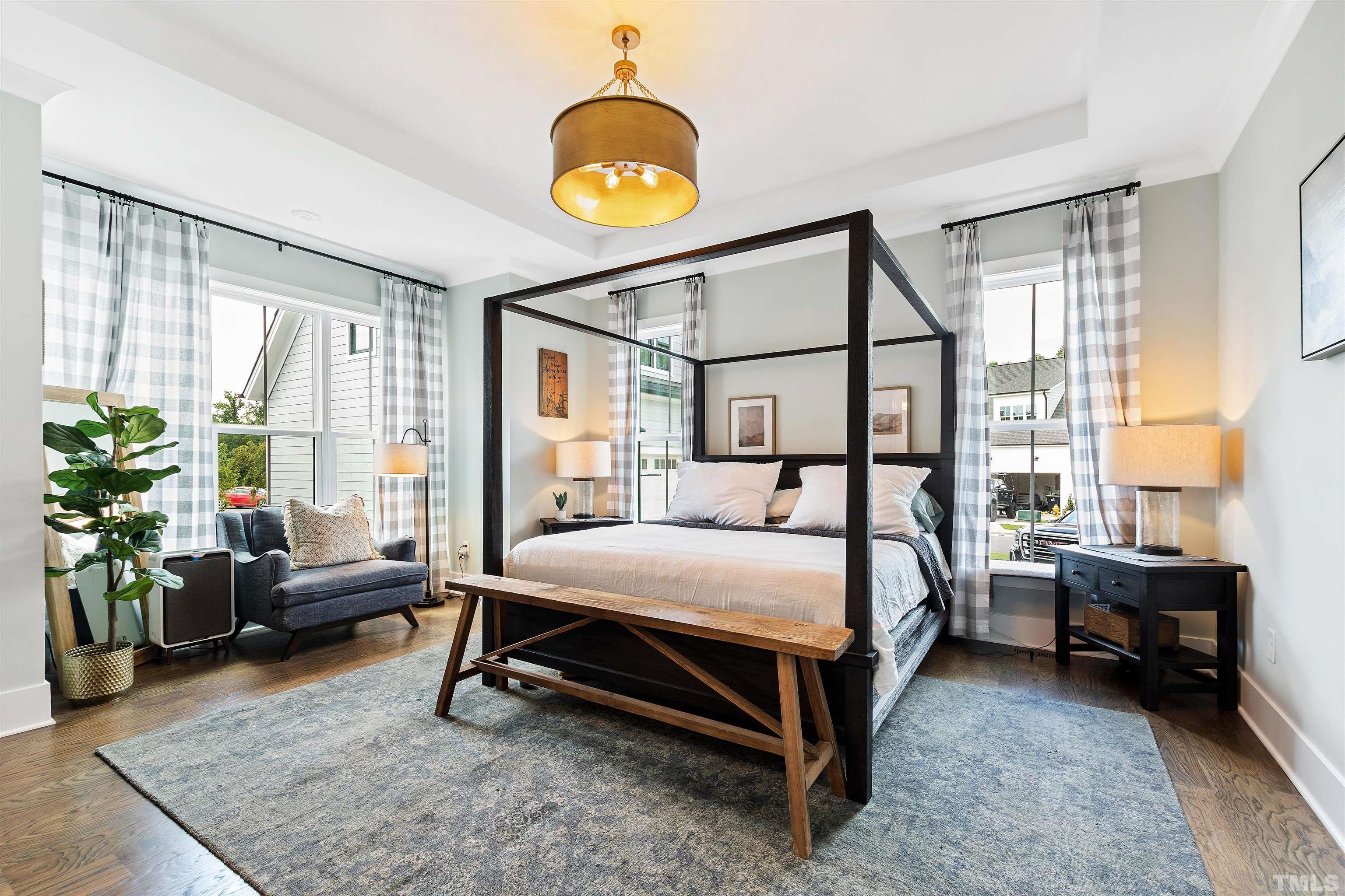 700 Daniel Ridge Rd. Wendell, NC 27591 - Photo 24 of 62 a bedroom with a bed a chandelier and a window