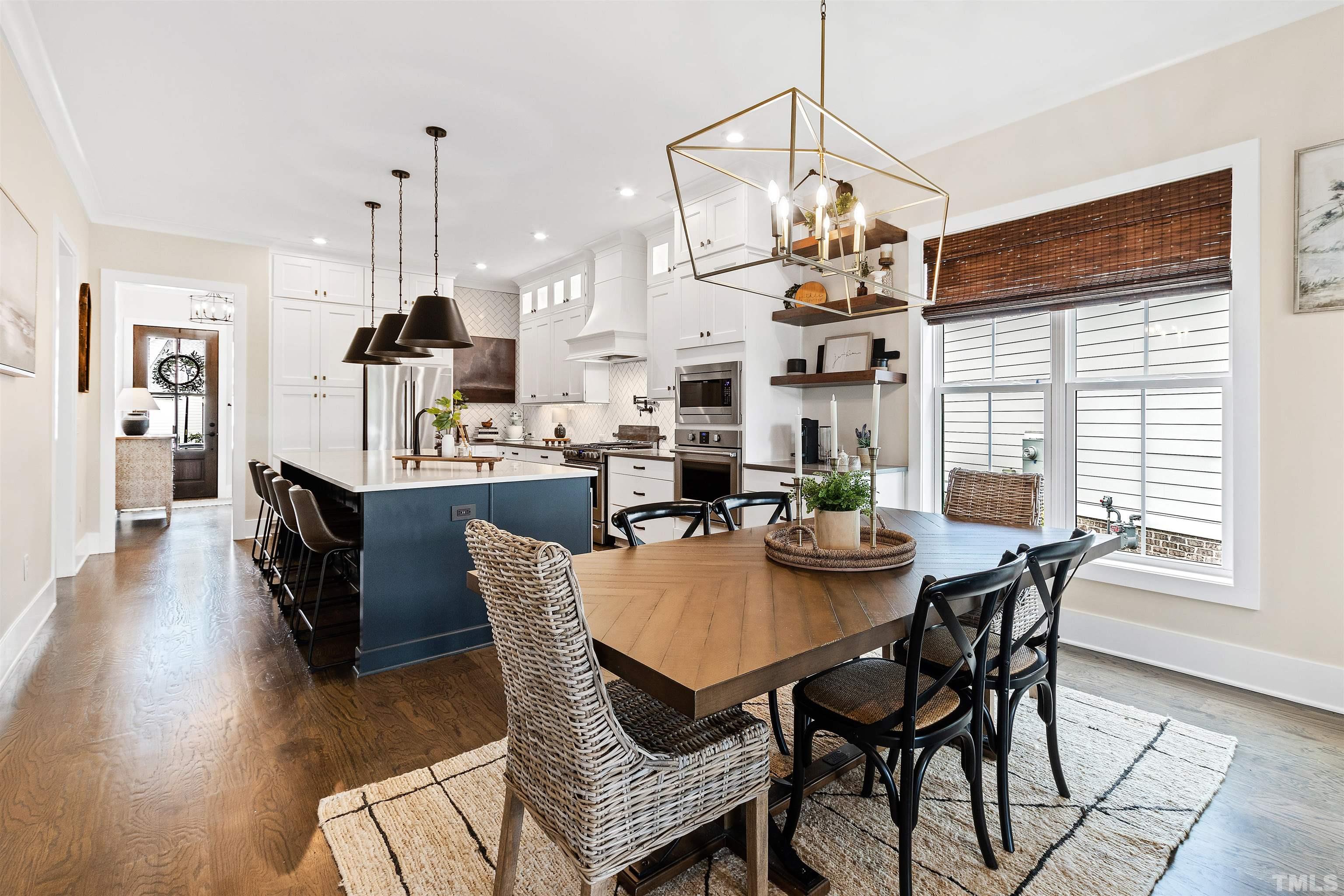 700 Daniel Ridge Rd. Wendell, NC 27591 - Photo 3 of 62 a dining room with furniture a chandelier and wooden floor