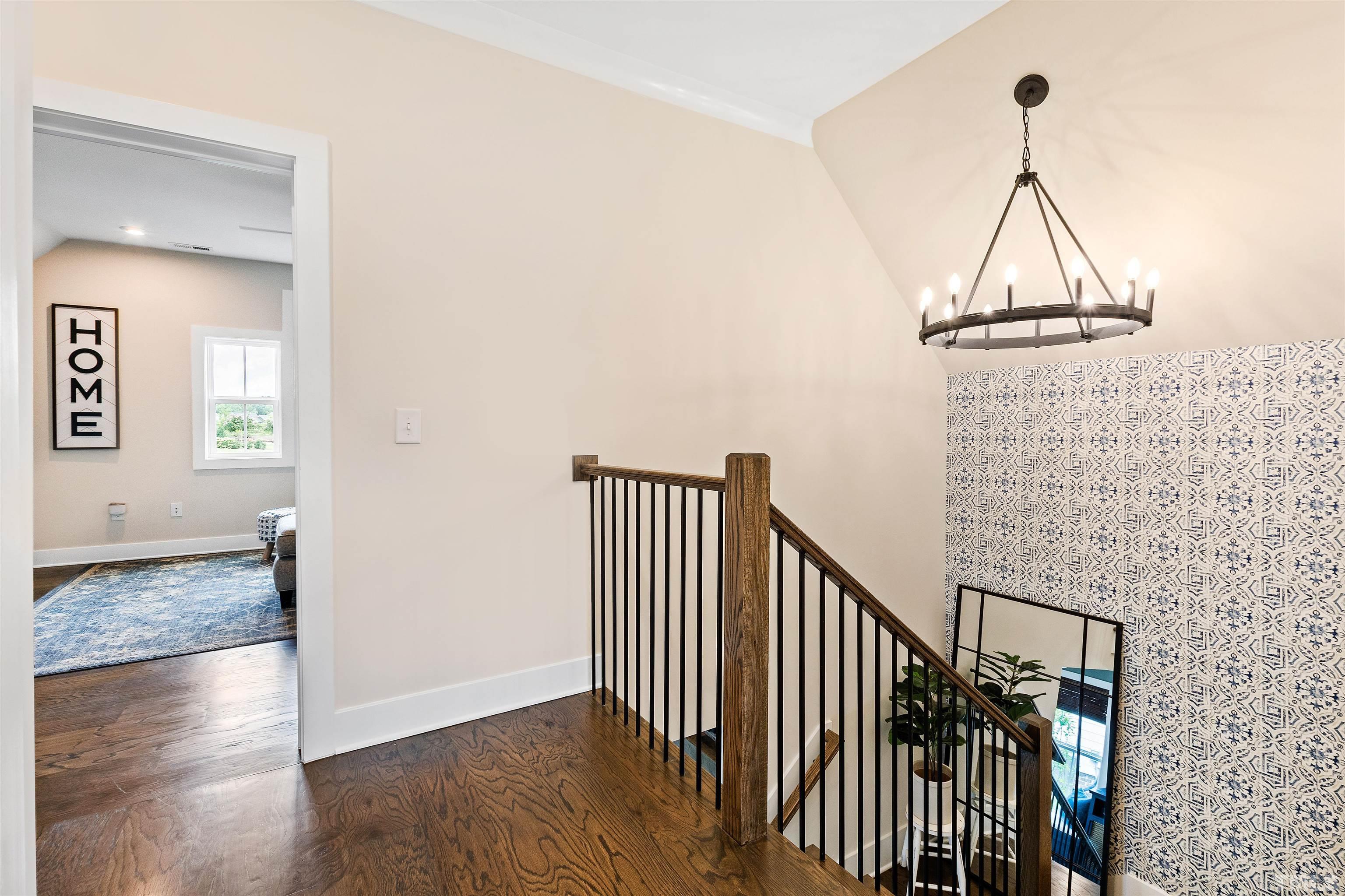 700 Daniel Ridge Rd. Wendell, NC 27591 - Photo 38 of 62 a view of a hallway with wooden floor and stairs