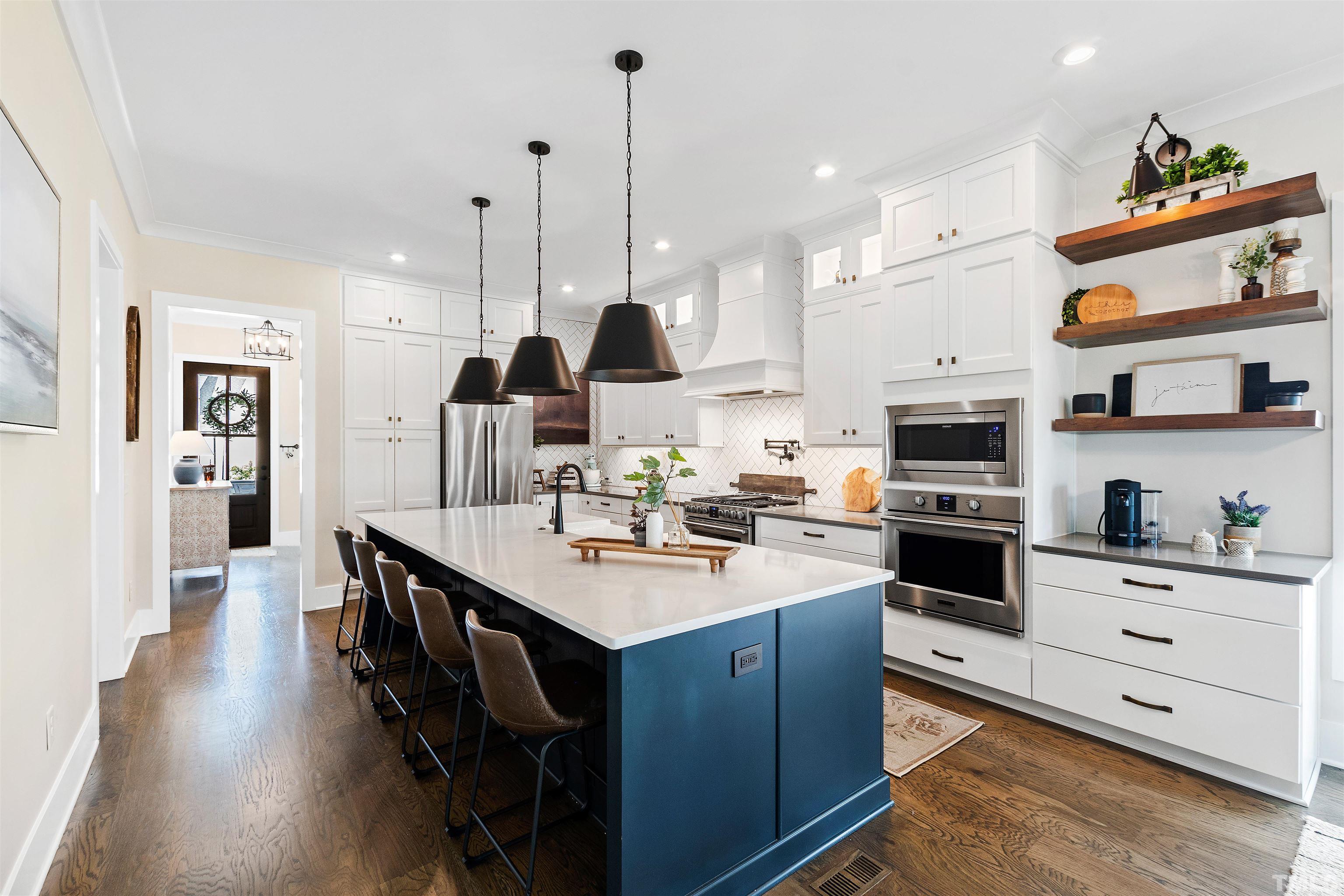 700 Daniel Ridge Rd. Wendell, NC 27591 - Photo 4 of 62 a kitchen with stainless steel appliances kitchen island granite countertop a sink a stove and a wooden floors