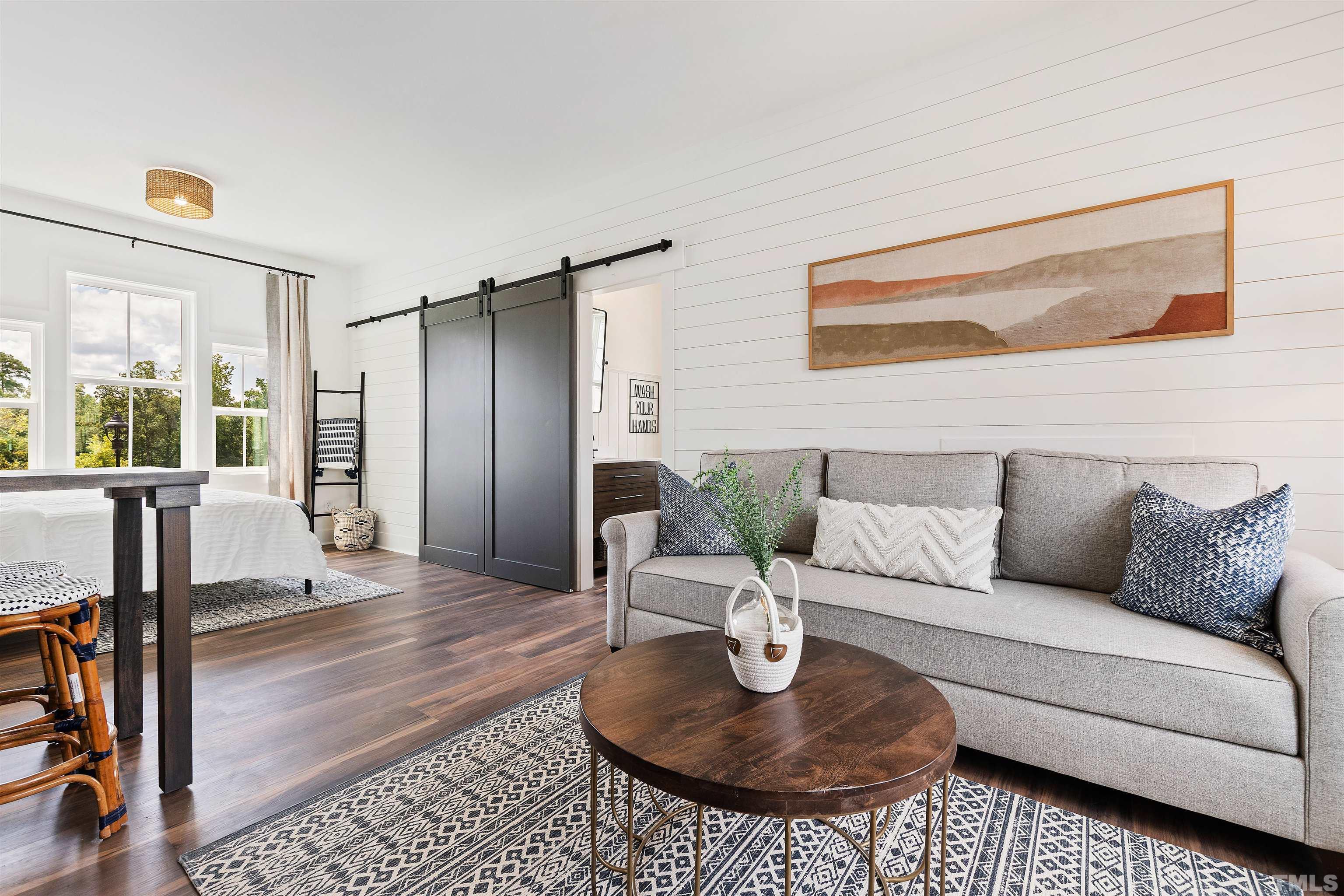 700 Daniel Ridge Rd. Wendell, NC 27591 - Photo 50 of 62 a living room with furniture and a dining table with wooden floor