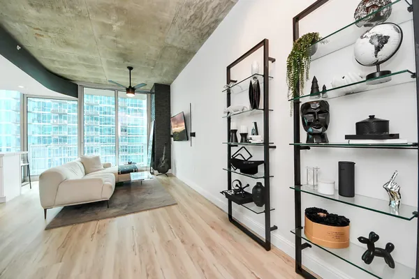 a living room with furniture and wooden floor