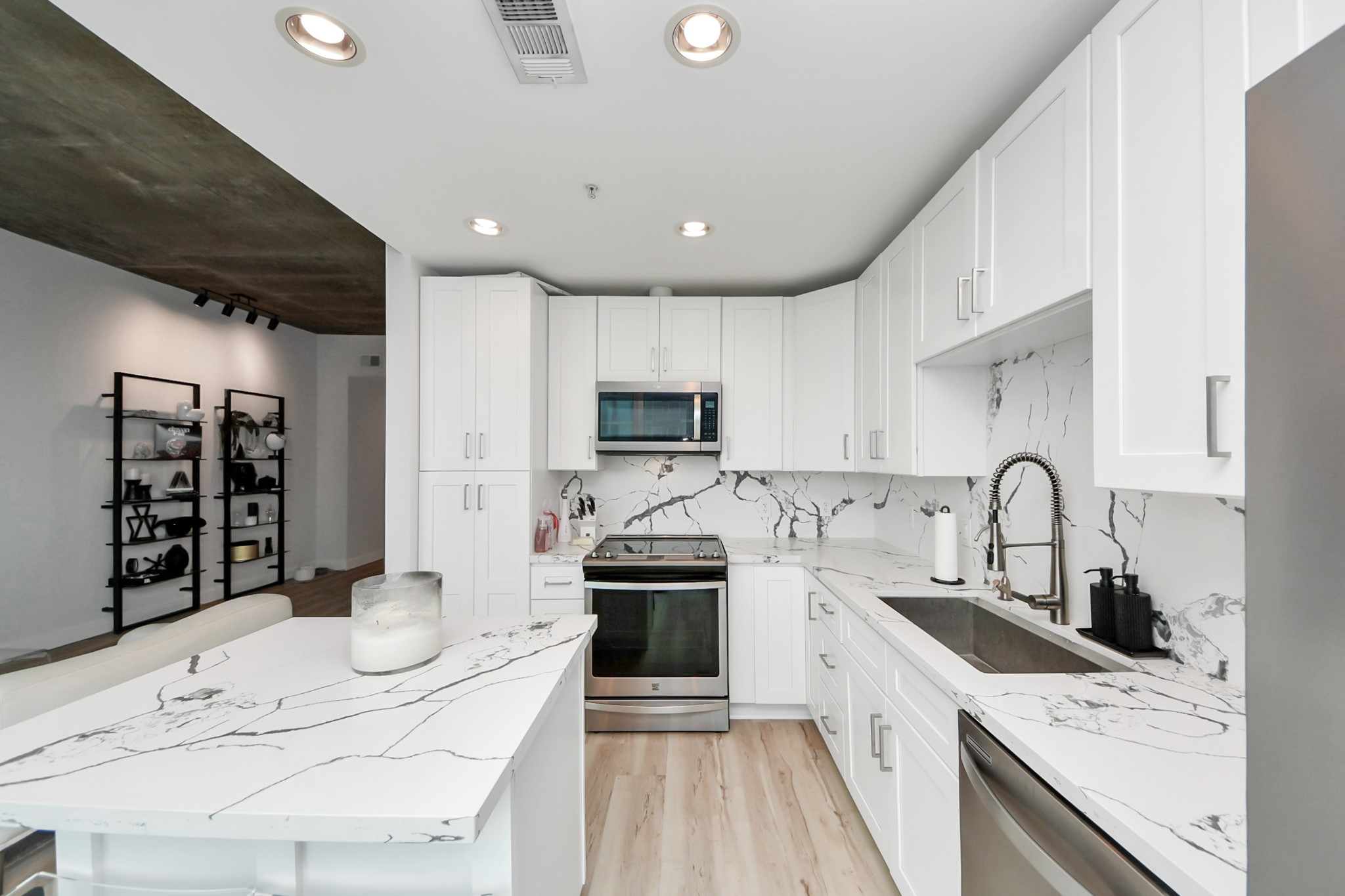 5925 Almeda Road, Unit 11616 Houston, TX 77004 - Photo 13 of 39 a kitchen with granite countertop a stove sink and cabinets