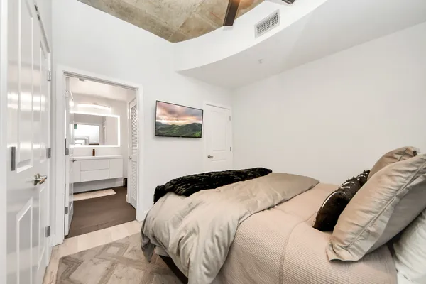 a bedroom with a bed and a view of bathroom