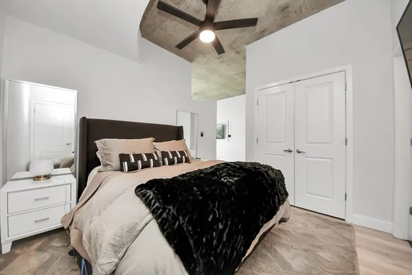 a bedroom with a bed and ceiling fan