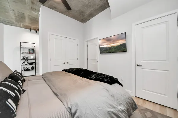 a bedroom with a bed and a flat screen tv