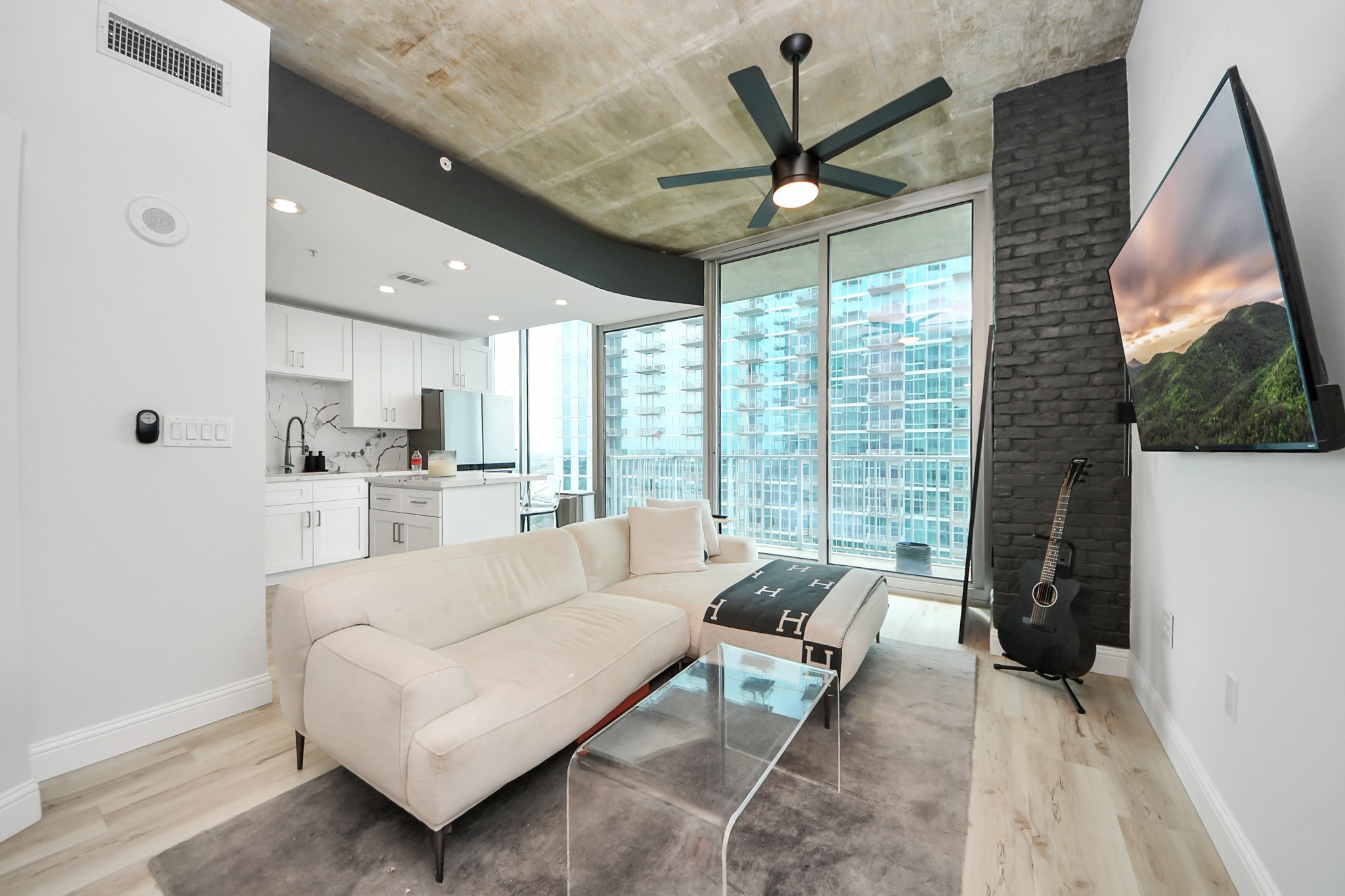 5925 Almeda Road, Unit 11616 Houston, TX 77004 - Photo 3 of 39 a living room with furniture a large window and a chandelier