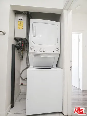 a bathroom with a granite countertop sink a toilet and a shower