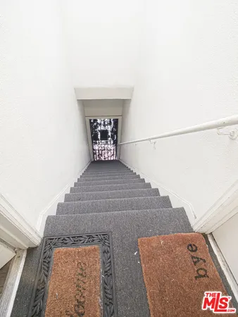 a view of a white house with many windows