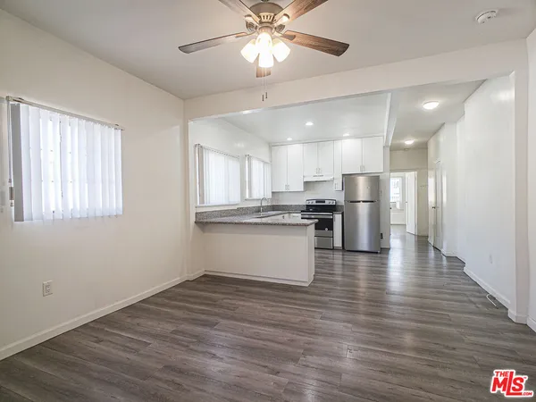 a view of kitchen with refrigerator and window
