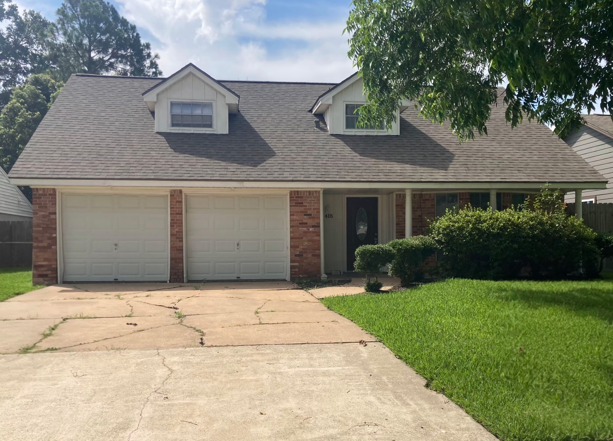 415 Cole Street Webster, TX 77598 - Photo 1 of 16 a front view of a house with a yard and garage