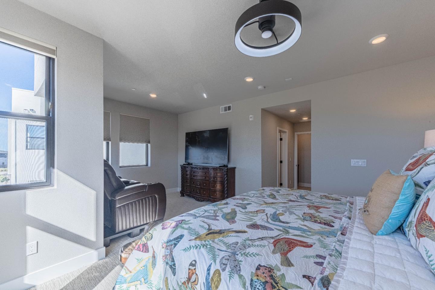135 8th Street Marina, CA 93933 - Photo 43 of 69 a spacious bedroom with a bed and a flat screen tv