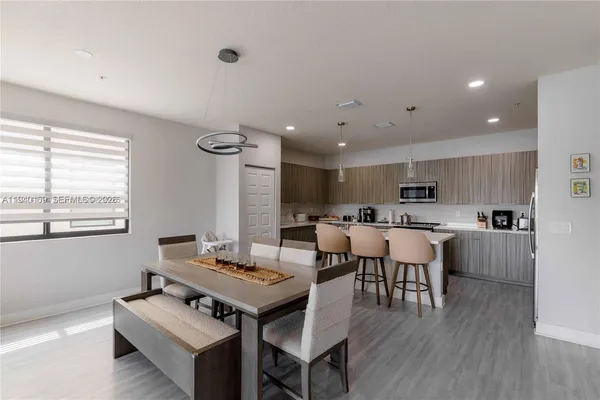 a view of a dining room with furniture and wooden floor