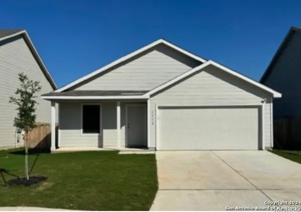 a view of a house with a yard and garage