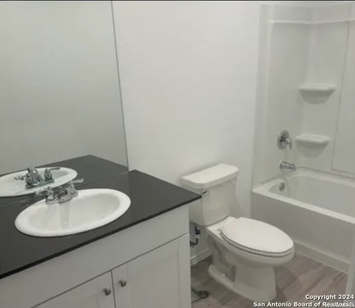 a bathroom with a sink a toilet and tub