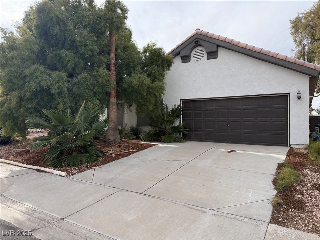 315 Modesto Street Henderson, NV 89014 - Photo 2 of 22 Recently painted but hiding its true character behind the tree!