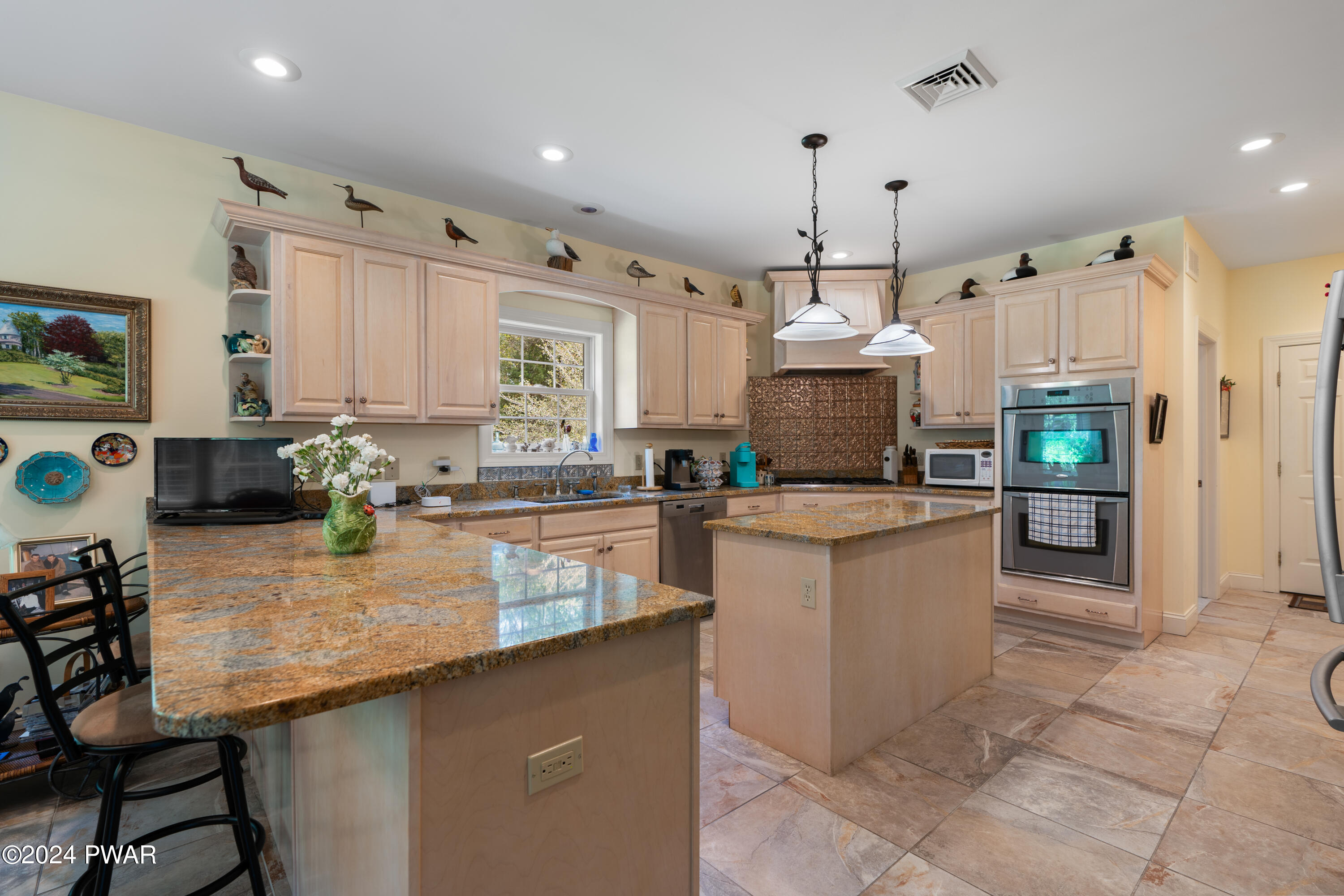 208 Long Meadow Road Milford, PA 18337 - Photo 24 of 64 a kitchen with kitchen island granite countertop a stove a sink a oven a dining table and chairs