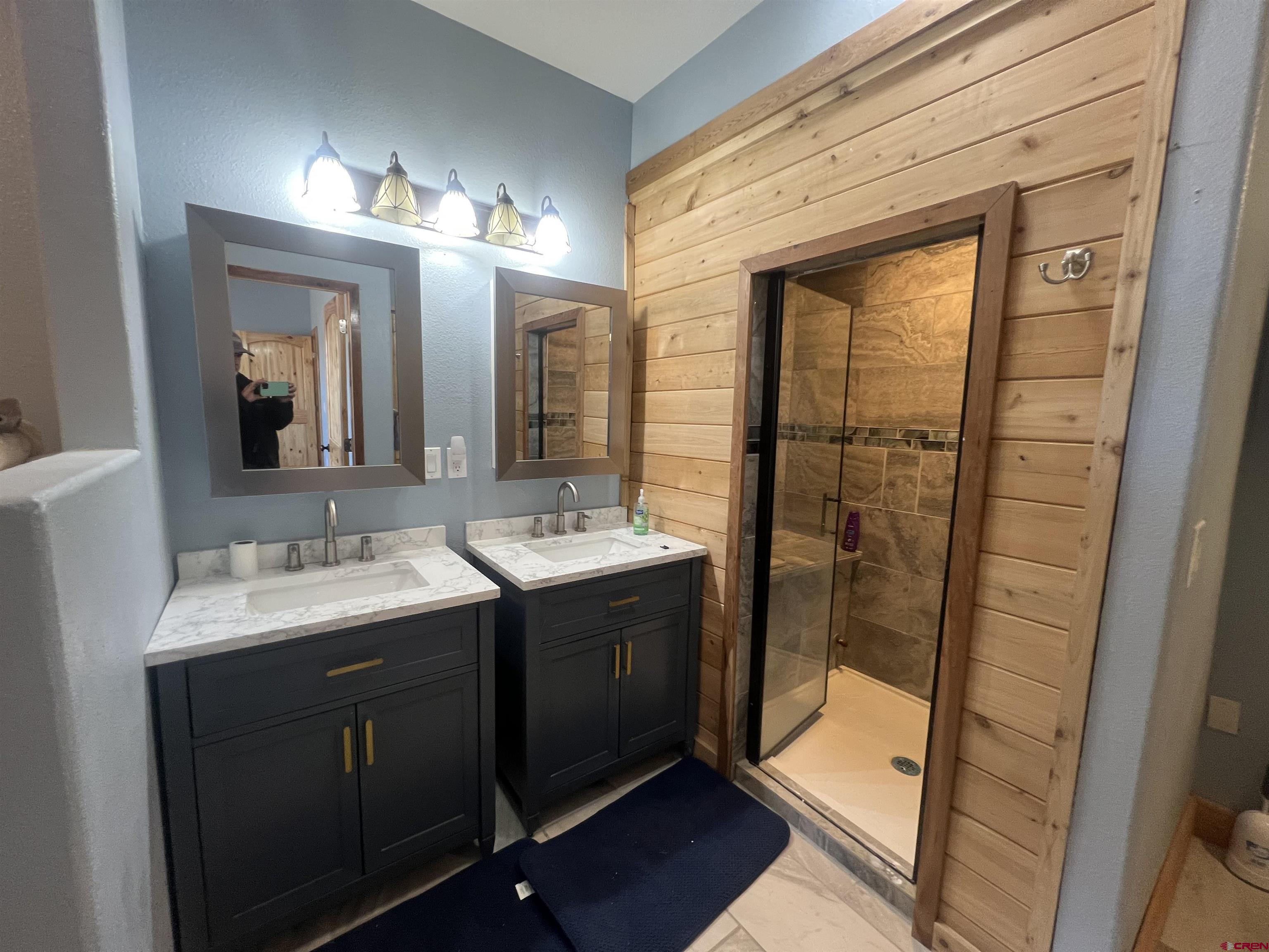 8504 Road 27 Cortez, CO 81321 - Photo 12 of 43 a bathroom with a double vanity sink and a mirror
