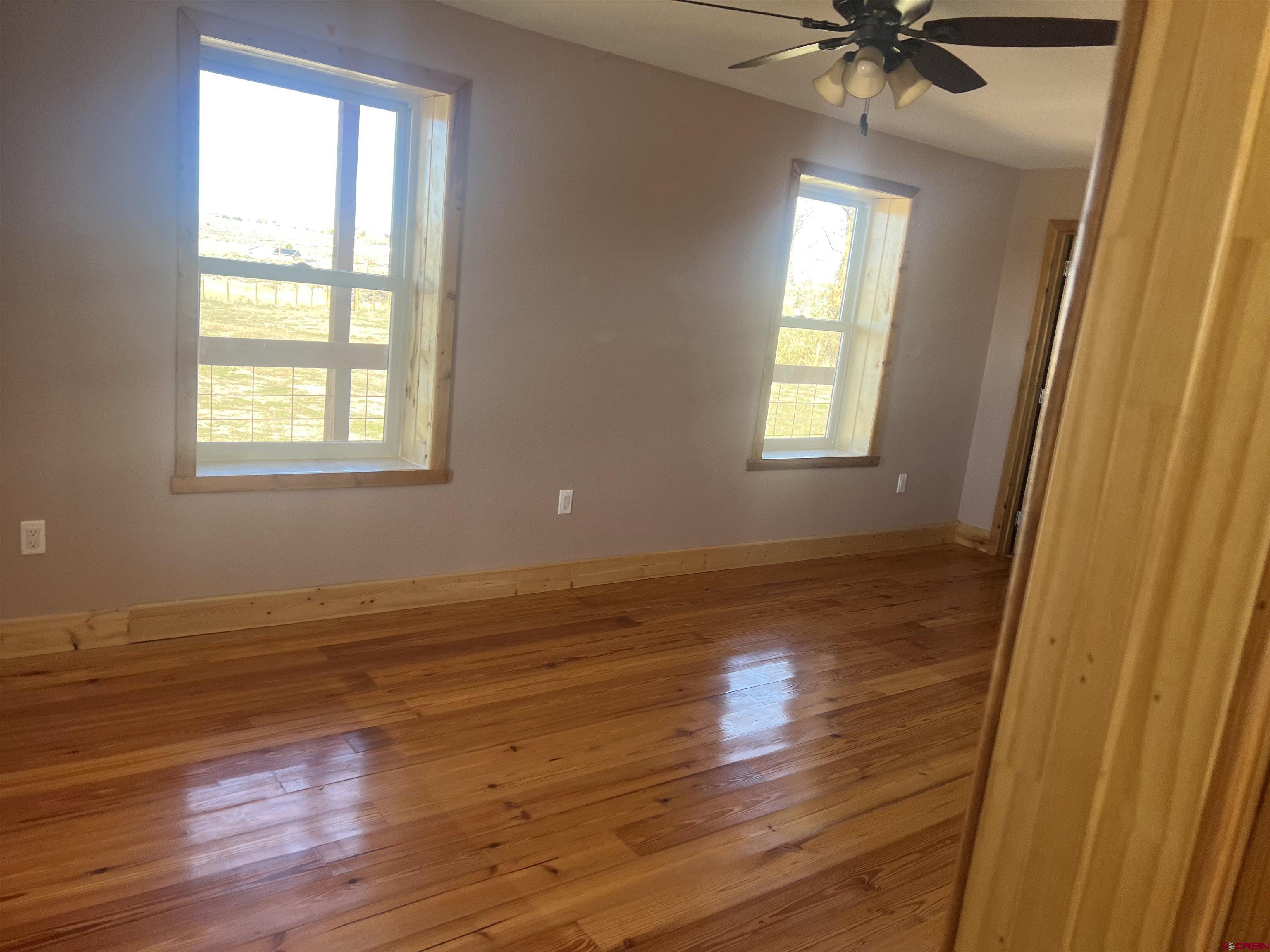 8504 Road 27 Cortez, CO 81321 - Photo 28 of 43 a view of an empty room with wooden floor and a window