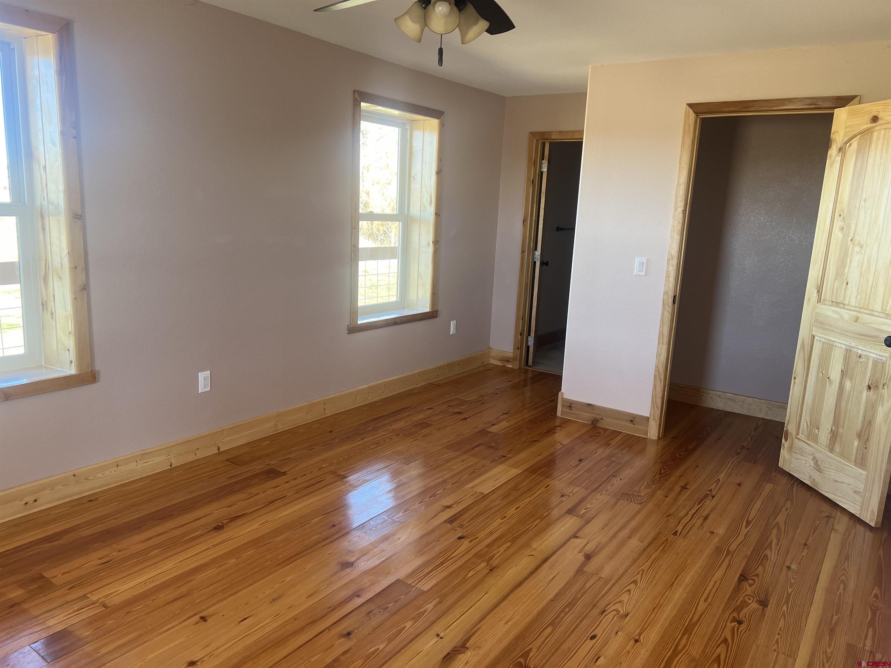 8504 Road 27 Cortez, CO 81321 - Photo 30 of 43 a view of an empty room with wooden floor and a window