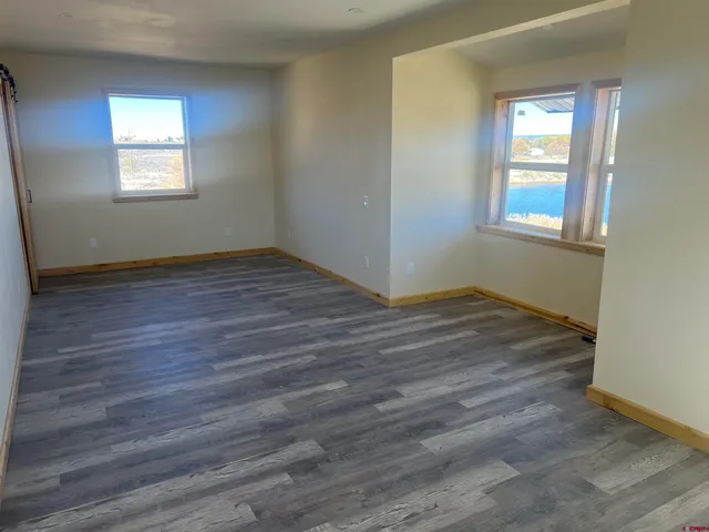 a kitchen with wooden floors and wooden cabinets