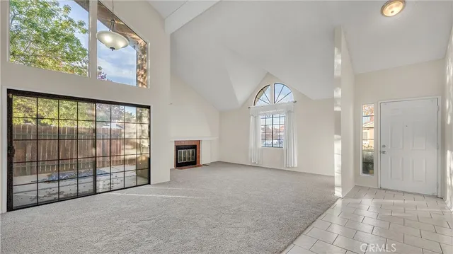 an empty room with windows and a ceiling fan