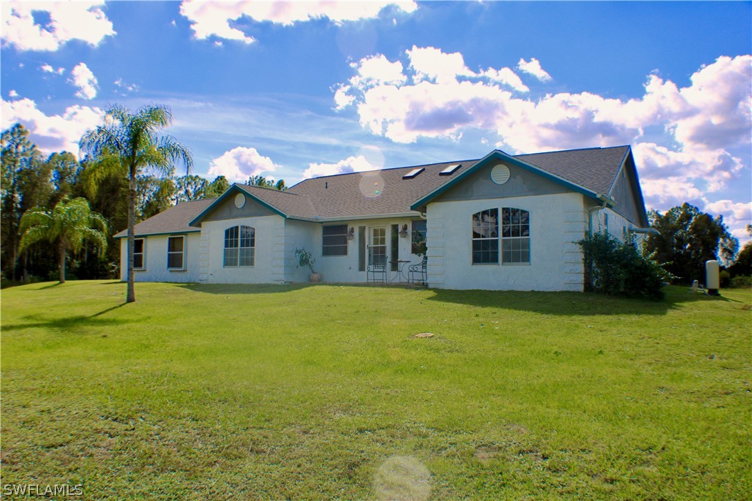 12210 Shawnee Road Fort Myers, FL 33913 - Photo 1 of 28 a front view of a house with yard