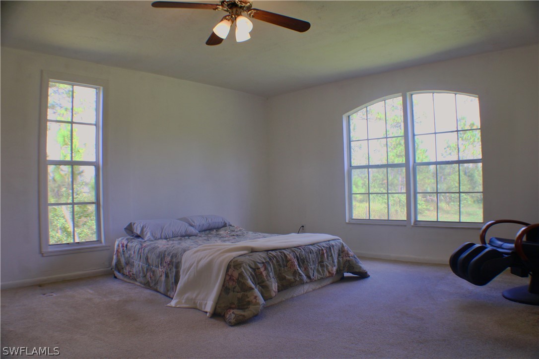12210 Shawnee Road Fort Myers, FL 33913 - Photo 11 of 28 a bedroom with a bed and a window