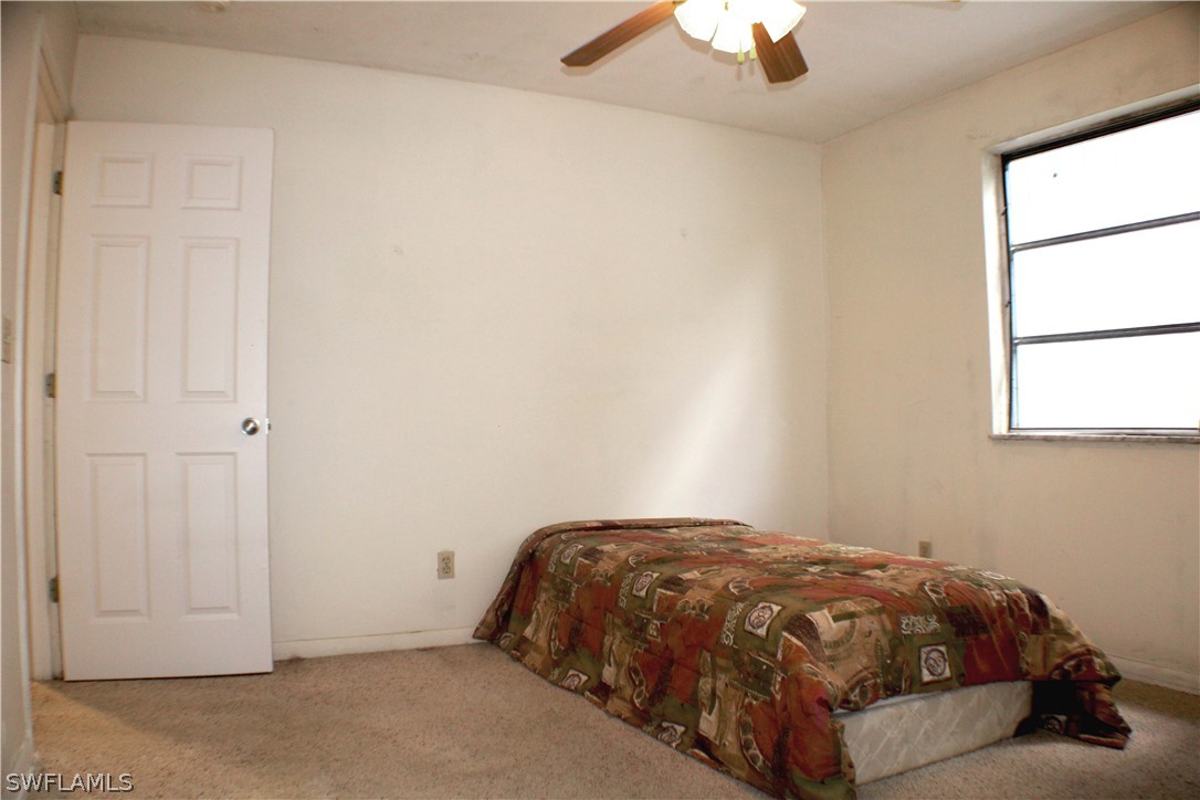 12210 Shawnee Road Fort Myers, FL 33913 - Photo 12 of 28 a bedroom with a bed and a window