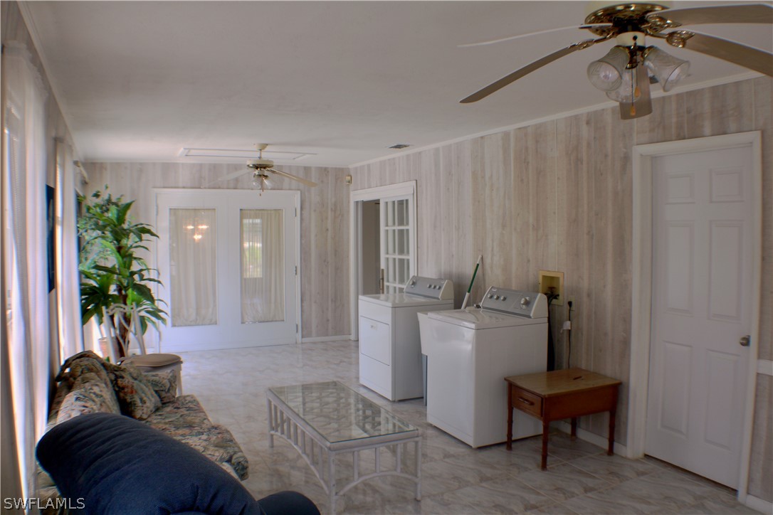 12210 Shawnee Road Fort Myers, FL 33913 - Photo 15 of 28 a living room with furniture and a chandelier