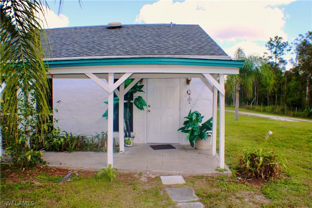 12210 Shawnee Road Fort Myers, FL 33913 - Photo 17 of 28 a front view of a house with garden