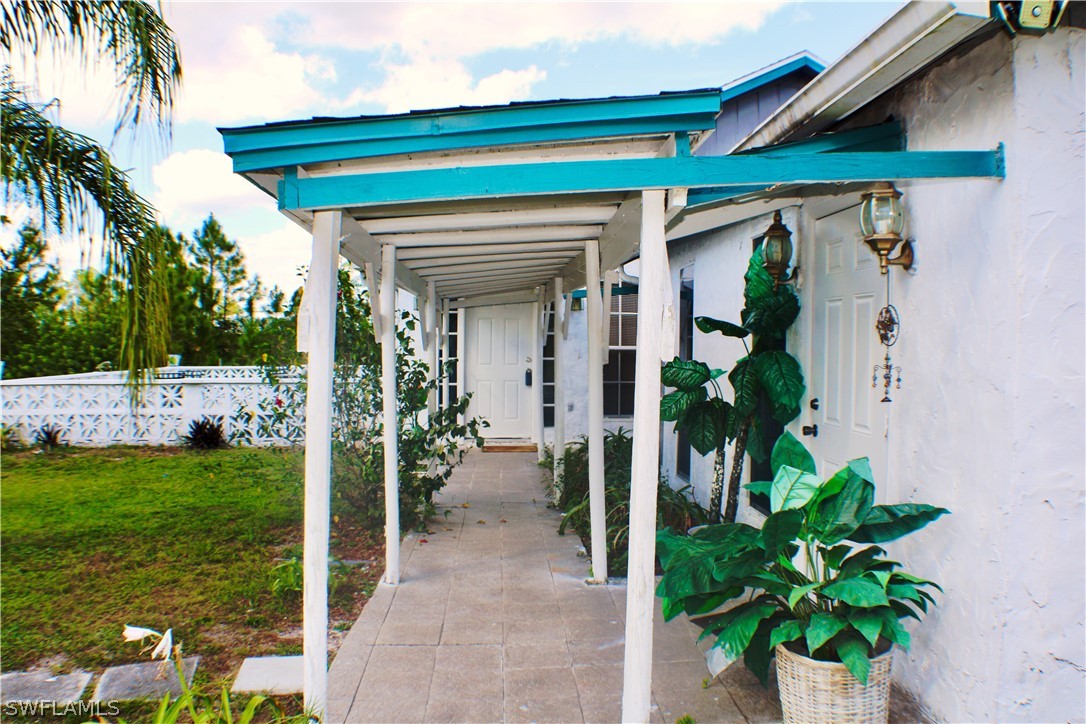 12210 Shawnee Road Fort Myers, FL 33913 - Photo 18 of 28 a front view of a house with a porch