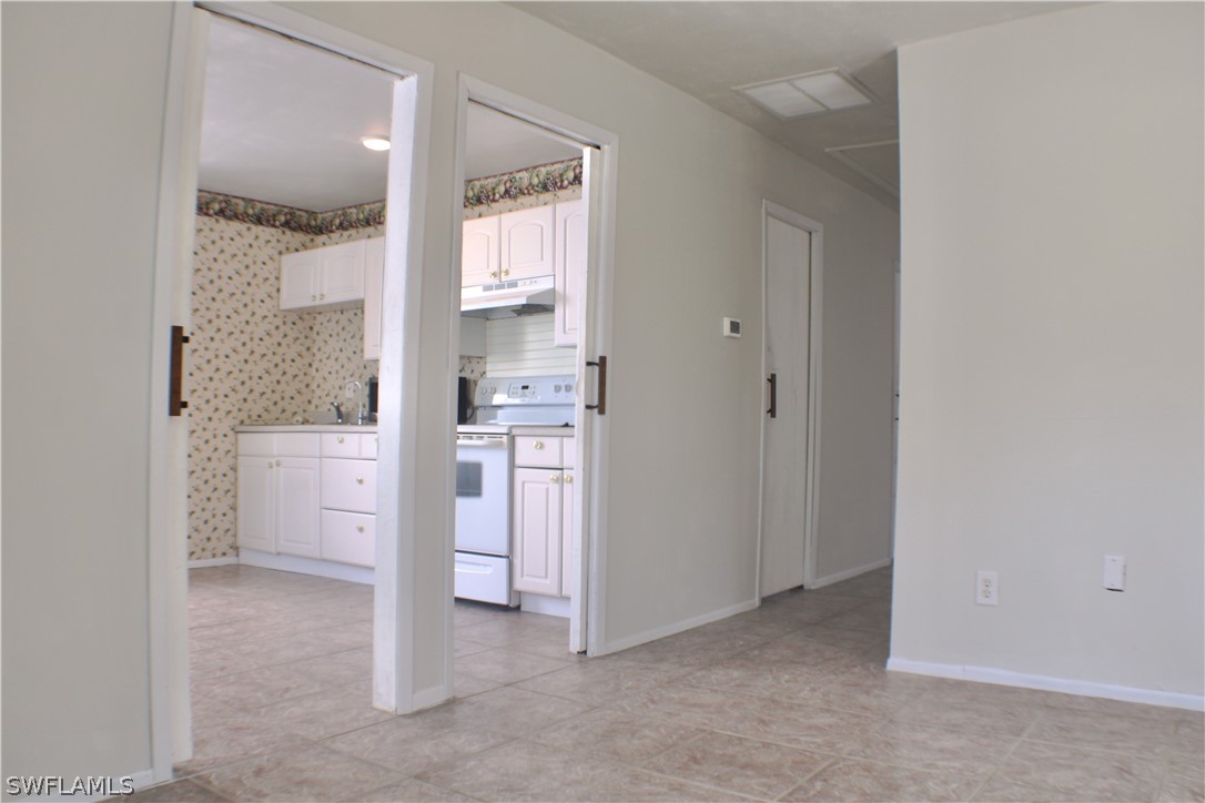 12210 Shawnee Road Fort Myers, FL 33913 - Photo 20 of 28 a view of cabinets and bathroom with a window