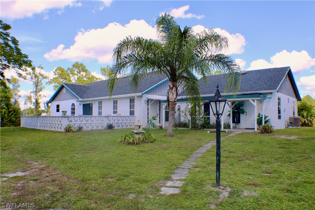 12210 Shawnee Road Fort Myers, FL 33913 - Photo 2 of 28 a front view of a house with garden