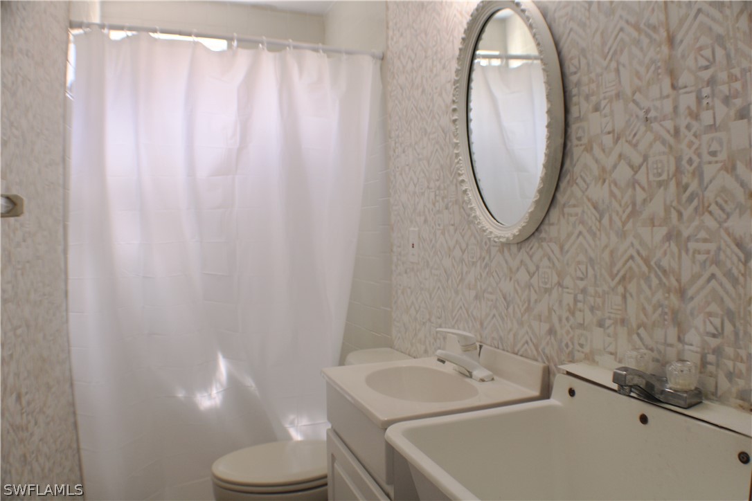 12210 Shawnee Road Fort Myers, FL 33913 - Photo 23 of 28 a bathroom with a sink a toilet and a mirror