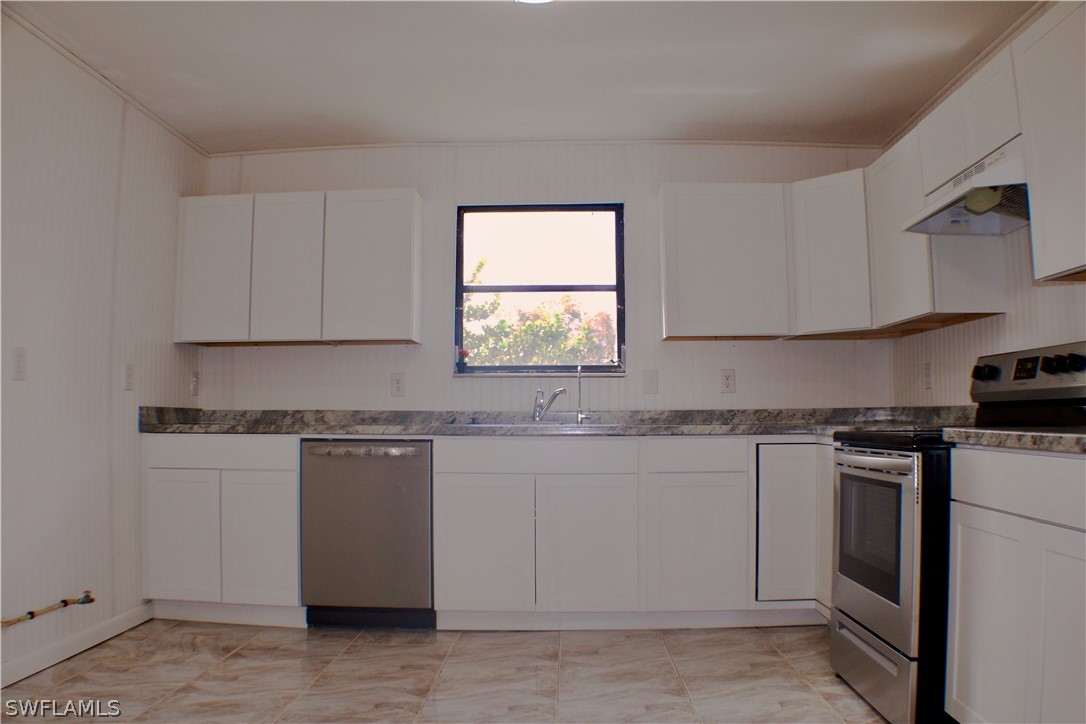 12210 Shawnee Road Fort Myers, FL 33913 - Photo 10 of 28 a kitchen with granite countertop white cabinets and white appliances