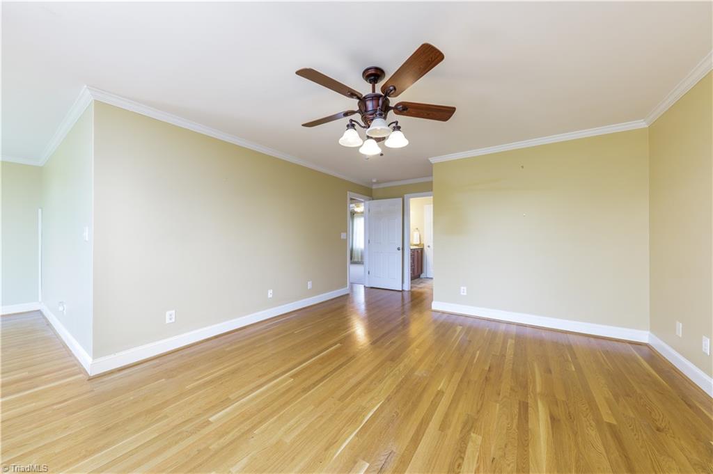 8504 Merriman Farm Road Oak Ridge, NC 27310 - Photo 20 of 47 Hardwood flooring in Primary Bedroom