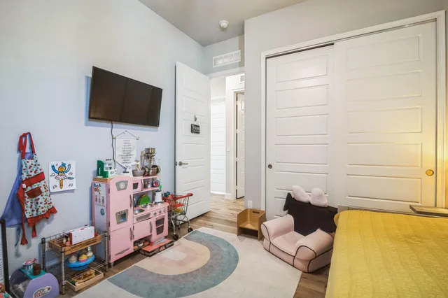 a bedroom with a bed and a chandelier