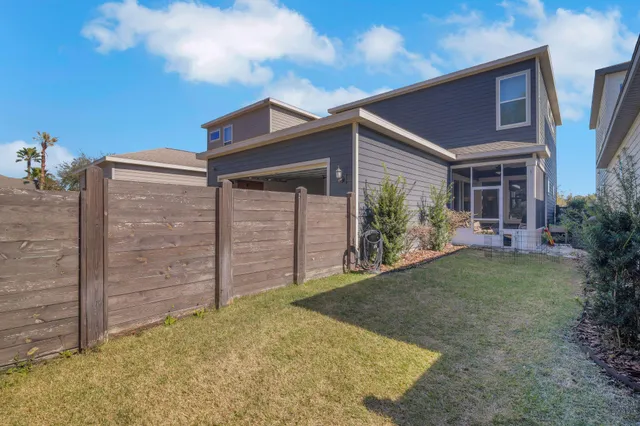 a view of a house with a backyard