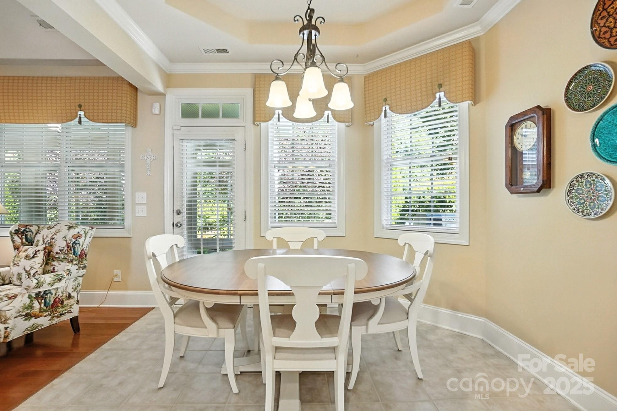 10906 Round Rock Road Charlotte, NC 28277 - Photo 13 of 45 a dining room with wooden floor and large windows