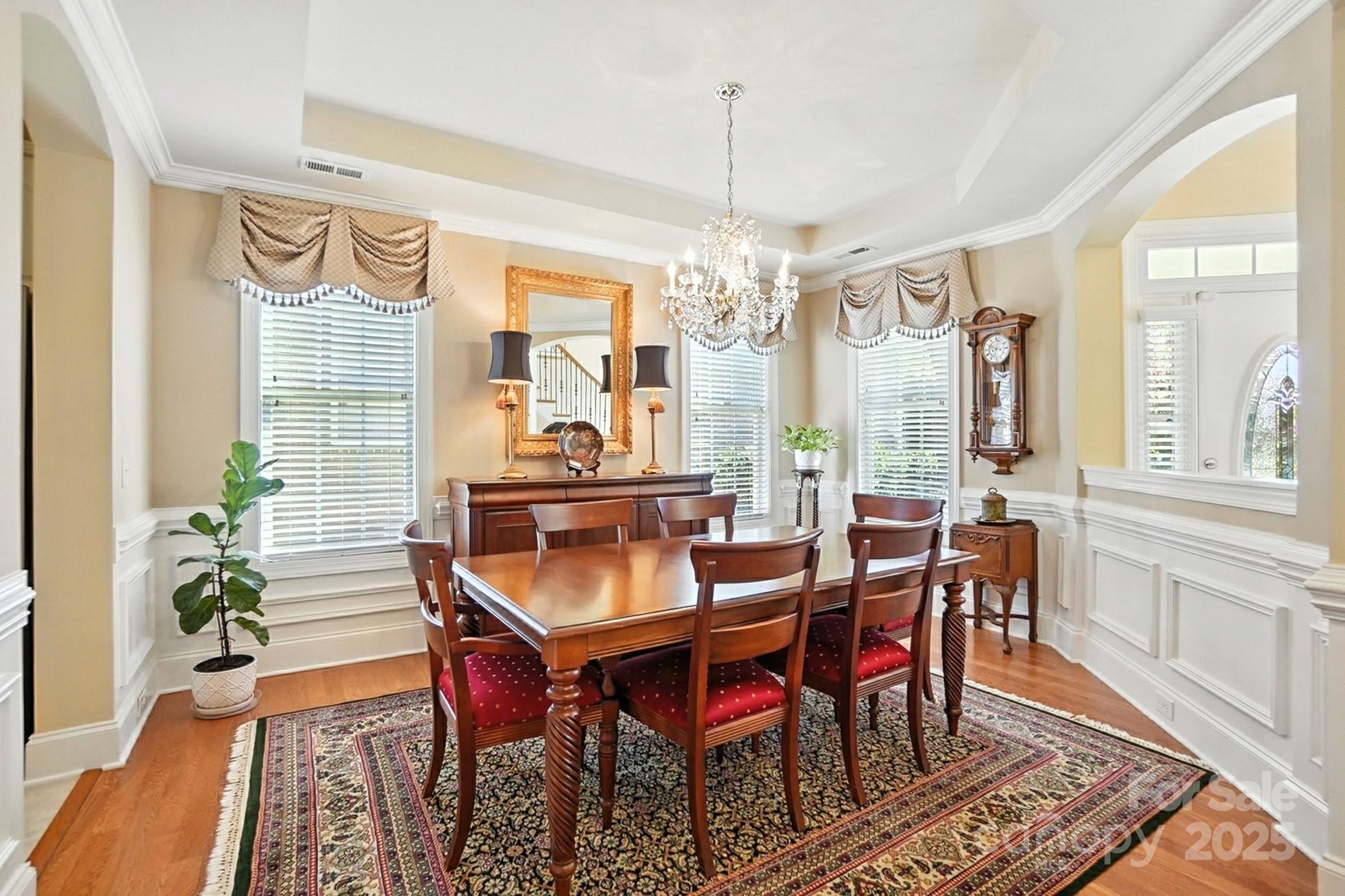 10906 Round Rock Road Charlotte, NC 28277 - Photo 14 of 45 a dining room with furniture a chandelier and wooden floor