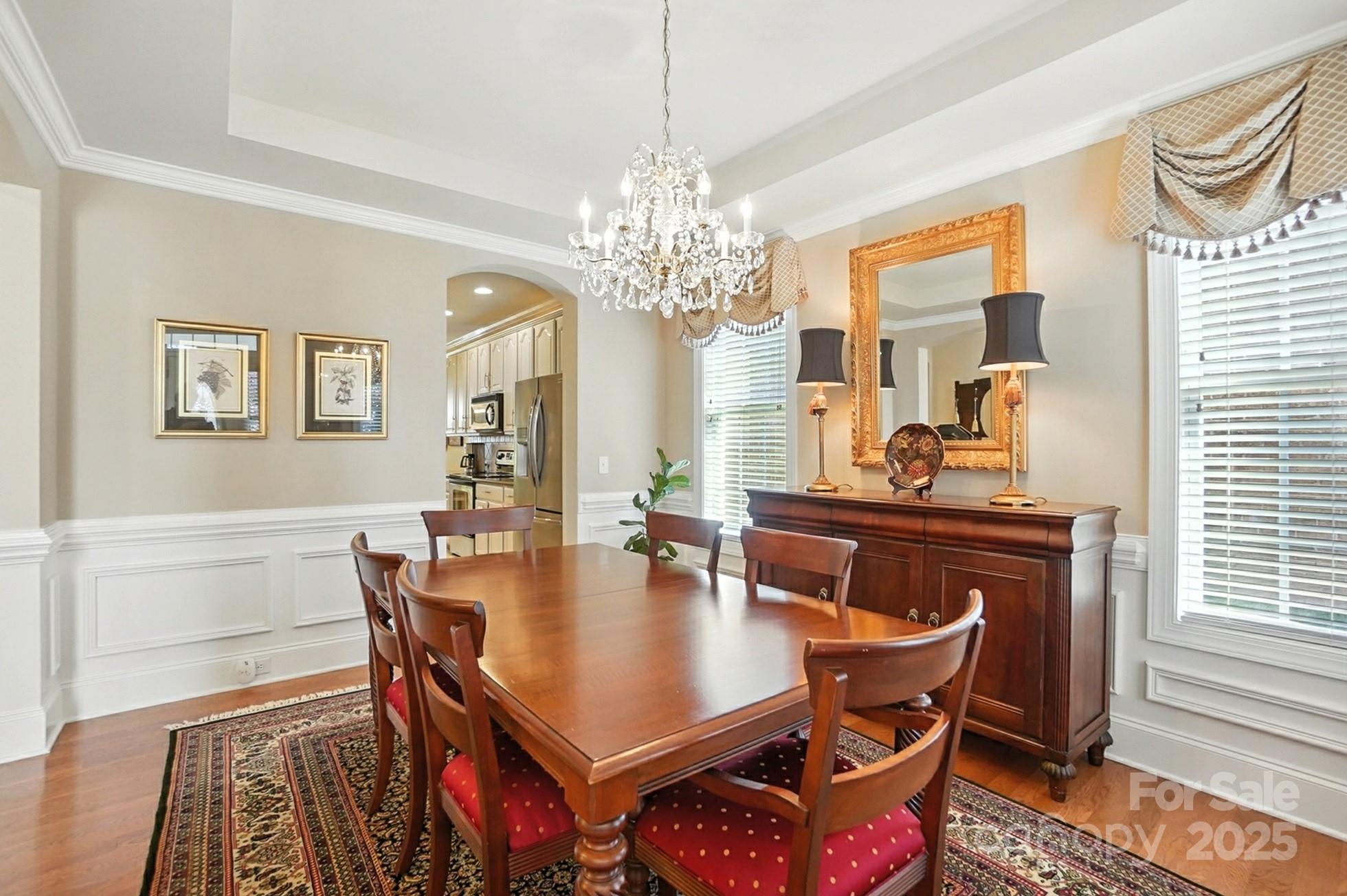 10906 Round Rock Road Charlotte, NC 28277 - Photo 15 of 45 a dining room with furniture a chandelier and wooden floor