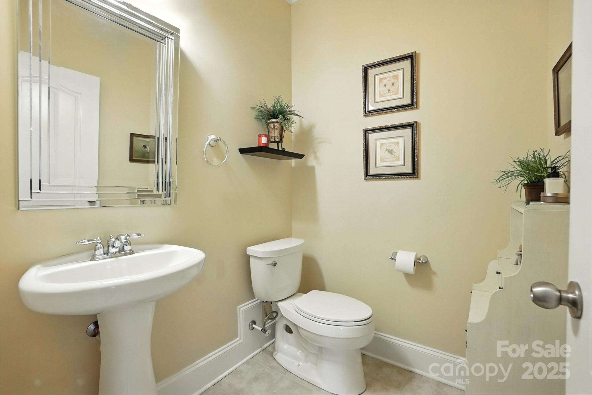 10906 Round Rock Road Charlotte, NC 28277 - Photo 16 of 45 a bathroom with a toilet sink and mirror