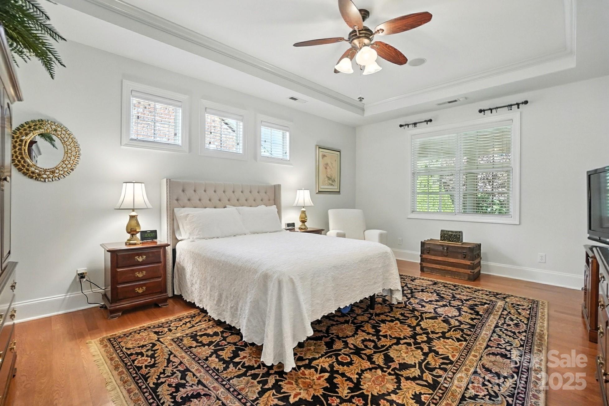 10906 Round Rock Road Charlotte, NC 28277 - Photo 17 of 45 a bedroom with a bed and a chandelier