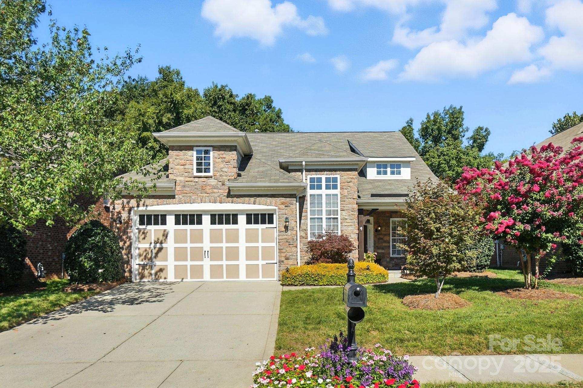 10906 Round Rock Road Charlotte, NC 28277 - Photo 2 of 45 a front view of a house with a garden